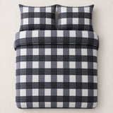 Overhead flat lay of the Seersucker Gingham charcoal duvet cover set with two matching pillowcases