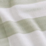 Macro close-up of the Seersucker Gingham green polycotton seersucker fabric