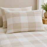 Close-up of Seersucker Gingham natural pillowcases showing the raised puckered check texture