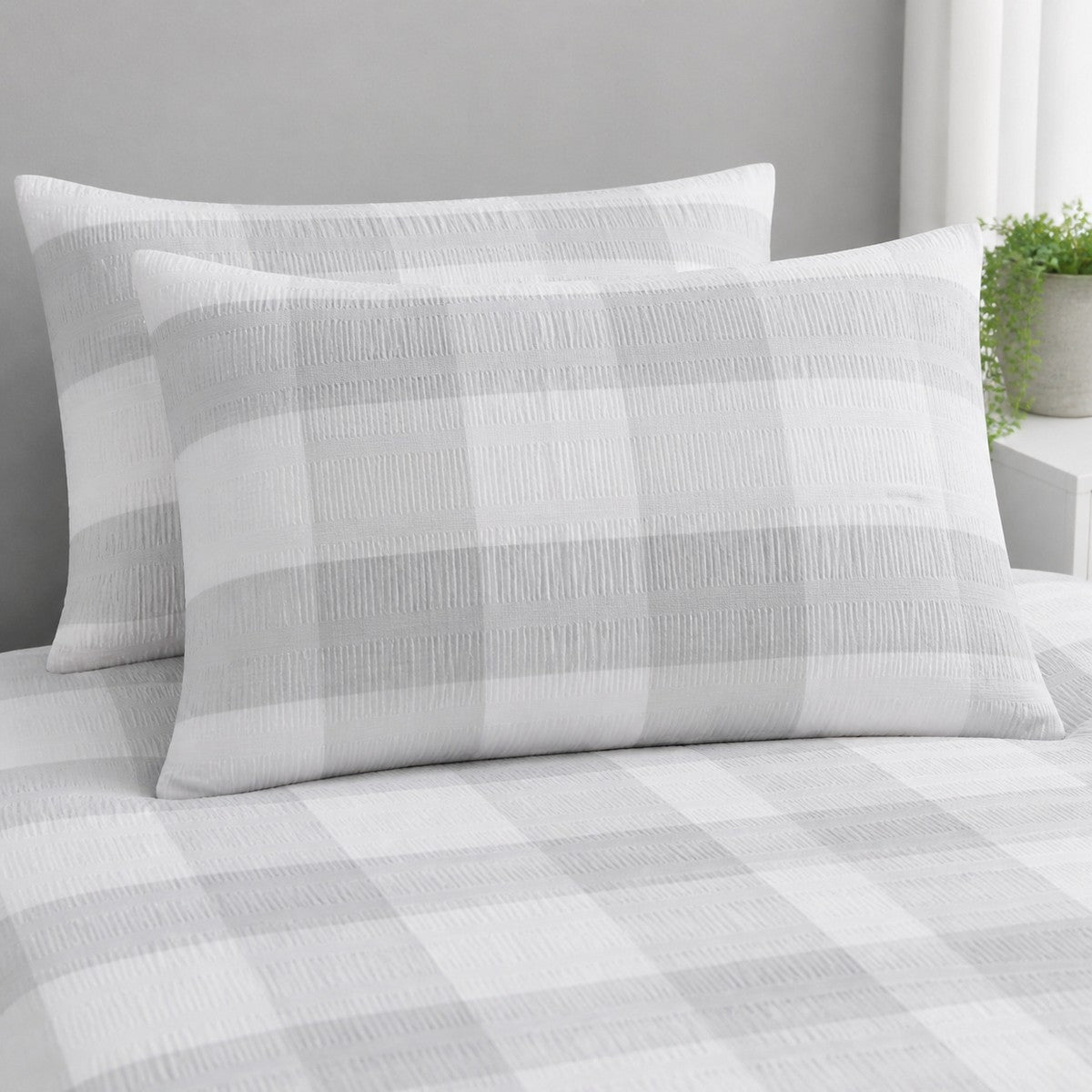 Close-up of Seersucker Gingham silver pillowcases showing the raised puckered check texture