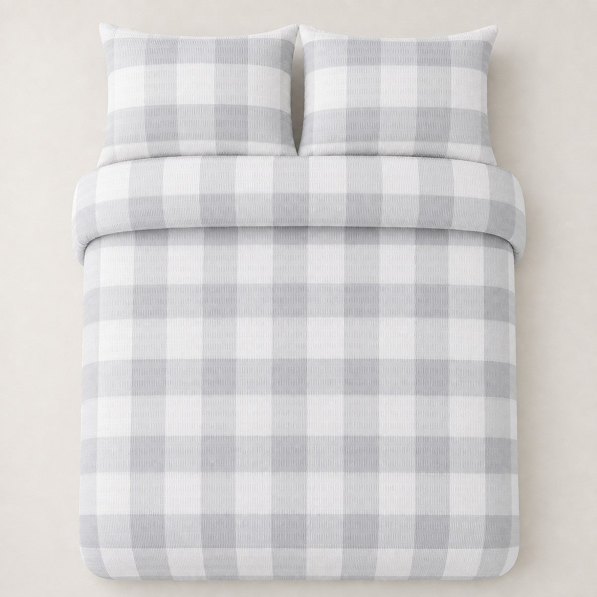 Overhead flat lay of the Seersucker Gingham silver duvet cover set with two matching pillowcases