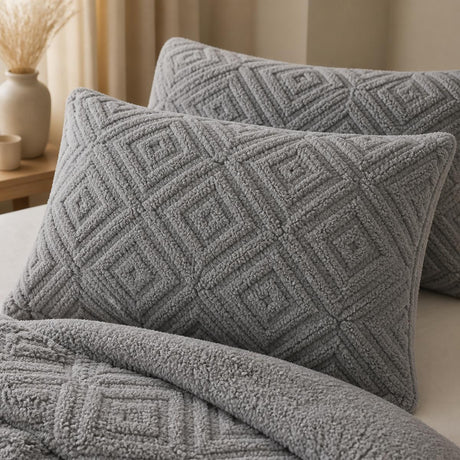 Close-up of grey Romo fleece pillowcases showing the raised geometric sherpa texture