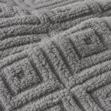 Macro close-up of the grey Romo microfibre fleece fabric with raised diamond pattern