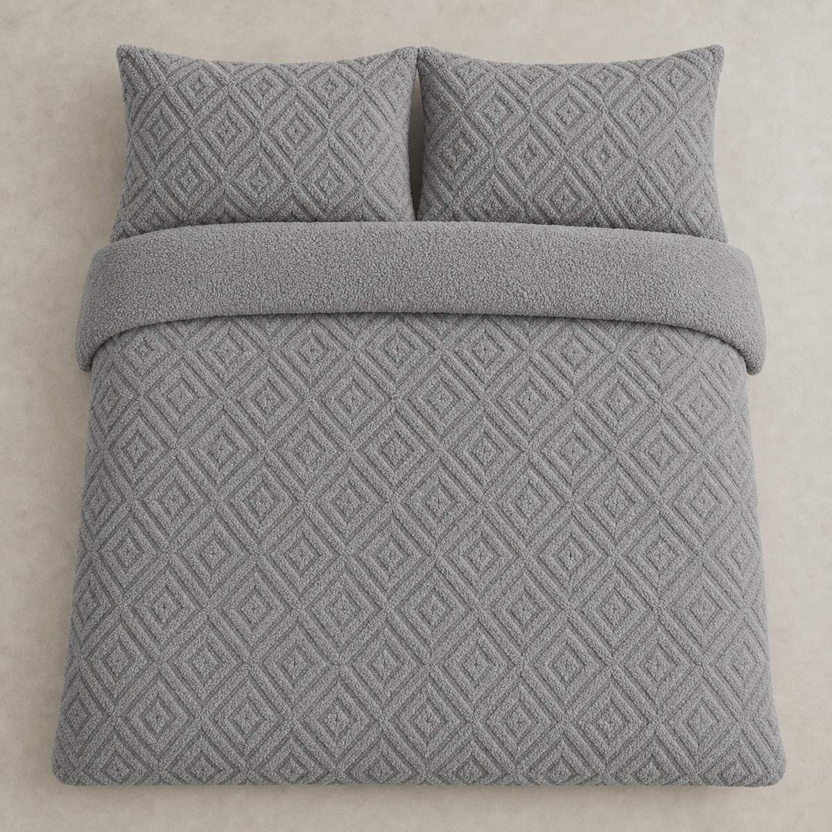 Overhead flat lay of the grey Romo fleece duvet cover set with two matching pillowcases
