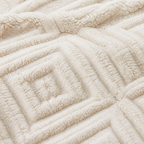 Macro close-up of the natural Romo microfibre fleece fabric with raised diamond pattern