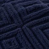 Macro close-up of the navy Romo microfibre fleece fabric with raised diamond pattern
