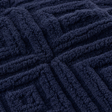 Macro close-up of the navy Romo microfibre fleece fabric with raised diamond pattern