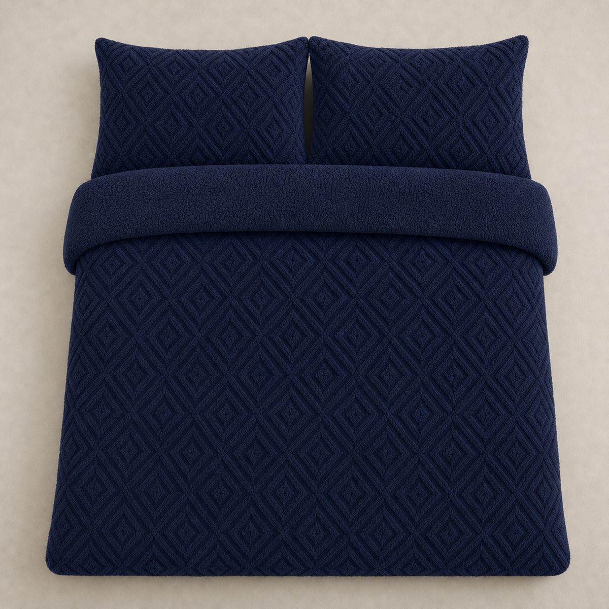 Overhead flat lay of the navy Romo fleece duvet cover set with two matching pillowcases