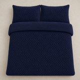 Overhead flat lay of the navy Romo fleece duvet cover set with two matching pillowcases