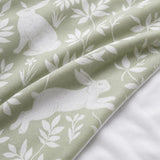 Macro close-up of the Spring Rabbits green polycotton duvet fabric with rabbit and leaf detail