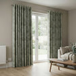 Living room with green patterned curtains and a sofa.
