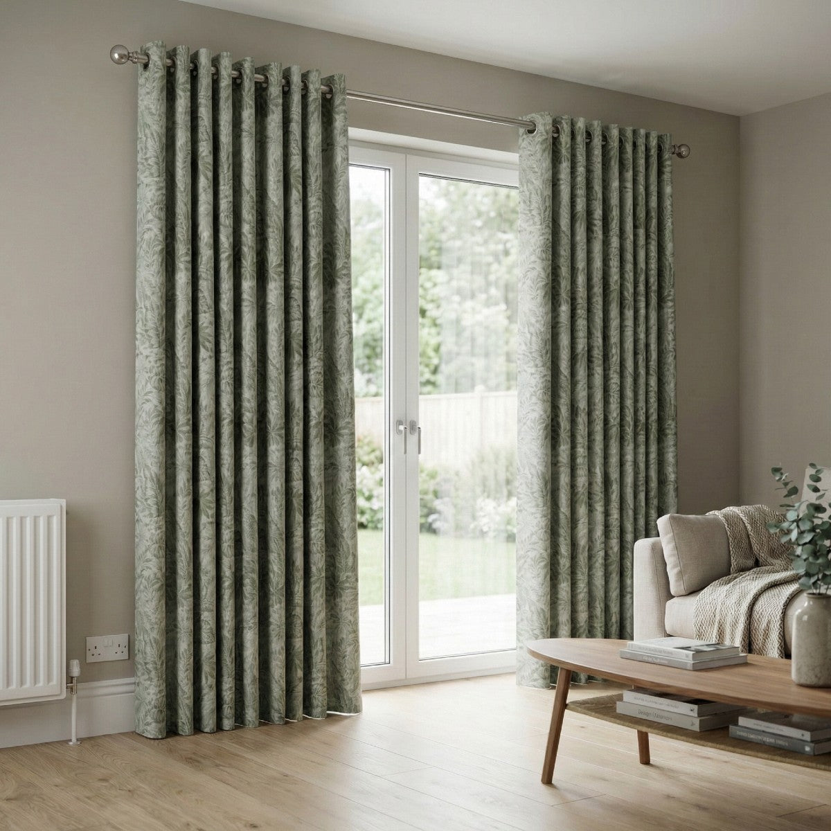 Living room with green patterned curtains and a sofa.